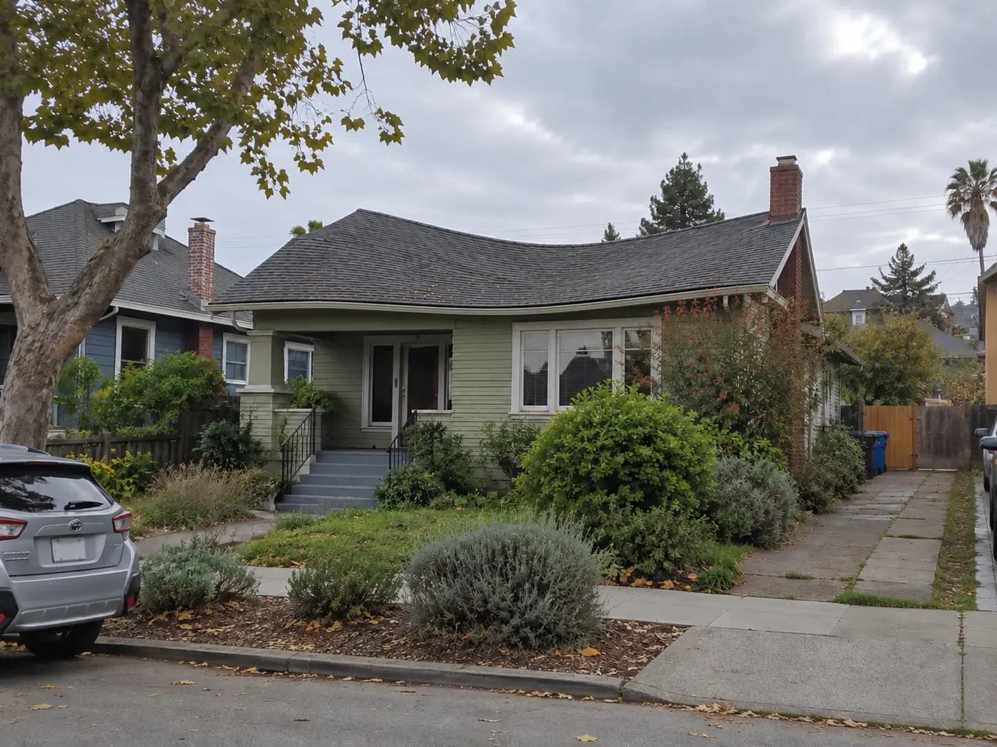 Slightly sagging shingle roofline on an Oakland home photographed from the street.